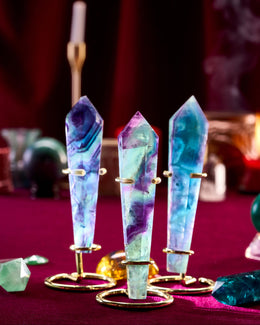 Three colorful crystal points on a stand